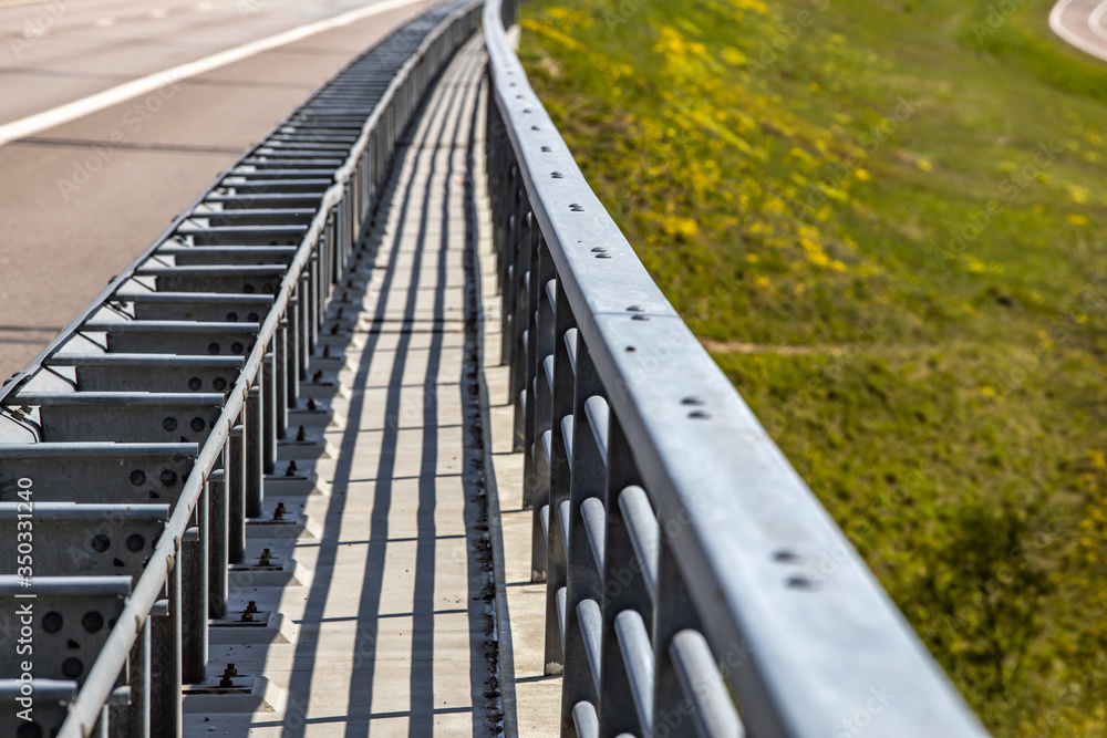 Perspective view of motorway bridge metal railings with depth of field. Perspective view of motorway bridge metal railings with depth of field.