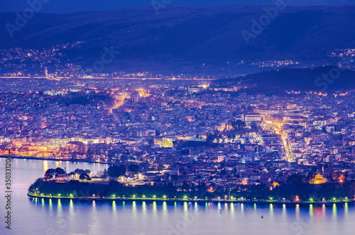Aerial view of the city of Ioannina and its lights reflecting in the lake during blue hour in Epirus Greece