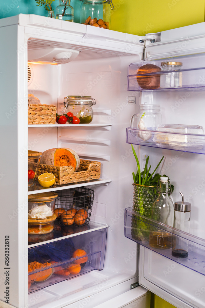 Opened fridge from the inside full of vegetables, fruits and other groceries beautiful order Opened fridge from the inside full of vegetables, fruits and other groceries beautiful order
