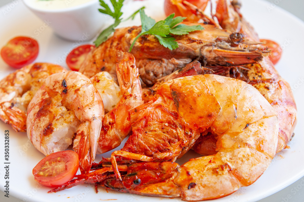 Several grilled tiger prawns on a white plate Several grilled tiger prawns on a white plate