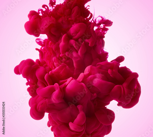 Color drop in water on pink background