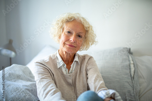 Close up serious elderly woman relaxing at home photo
