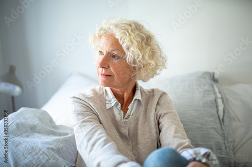 Close up elderly woman relaxing on couch at home