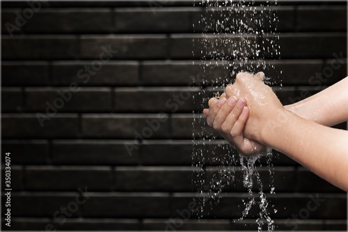 Human washing hands in clean water