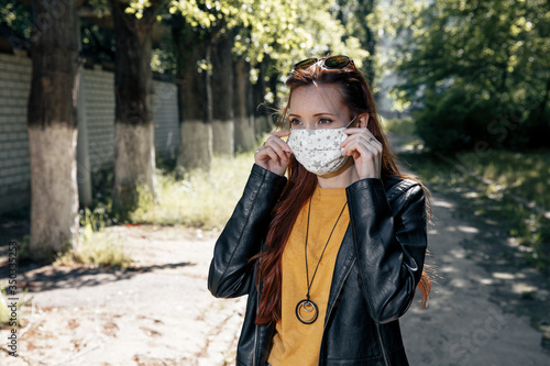 young woman in protective mask covid-19