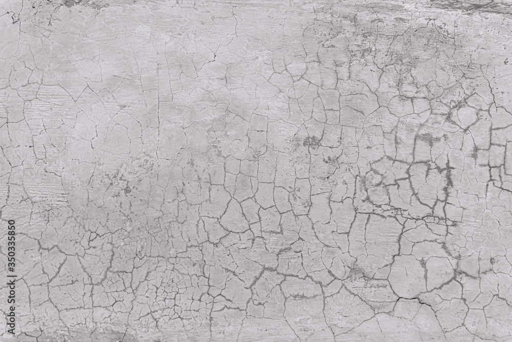 Texture of an old white wall with a lot of cracks Texture of an old white wall with a lot of cracks