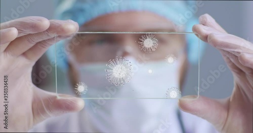 Scientist, physician, surgeon, inspect technological digital holographic plate represented coronavirus, ncov-2019. Futuristic medicine, man examines illustration of a virus molecule Coronavirus 19ncov photo