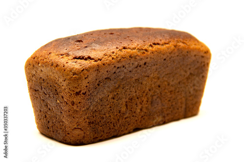 Black bread in the shape of a brick on a white background