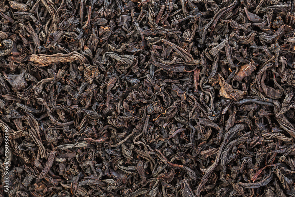 Dried Tea Leaves. The texture of large leaf black tea. Closeup. Dried Tea Leaves. The texture of large leaf black tea. Closeup.