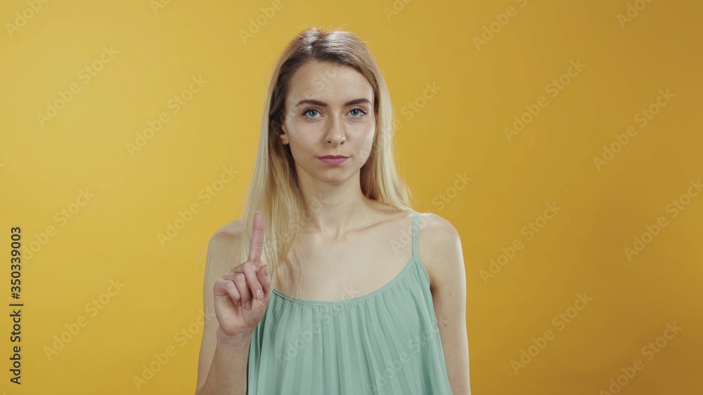 No way. It is not allowed. Young caucasian woman saying no rejecting shaking her finger negatively looking serious at camera isolated. Warning, prohibition concept. No way. It is not allowed. Young caucasian woman saying no rejecting shaking her finger negatively looking serious at camera isolated. Warning, prohibition concept.