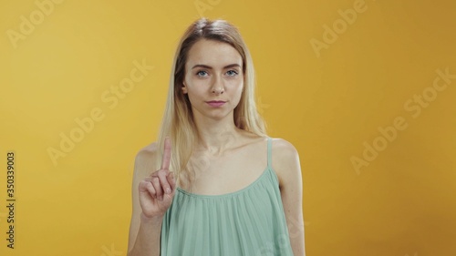 No way. It is not allowed. Young caucasian woman saying no rejecting shaking her finger negatively looking serious at camera isolated. Warning, prohibition concept.