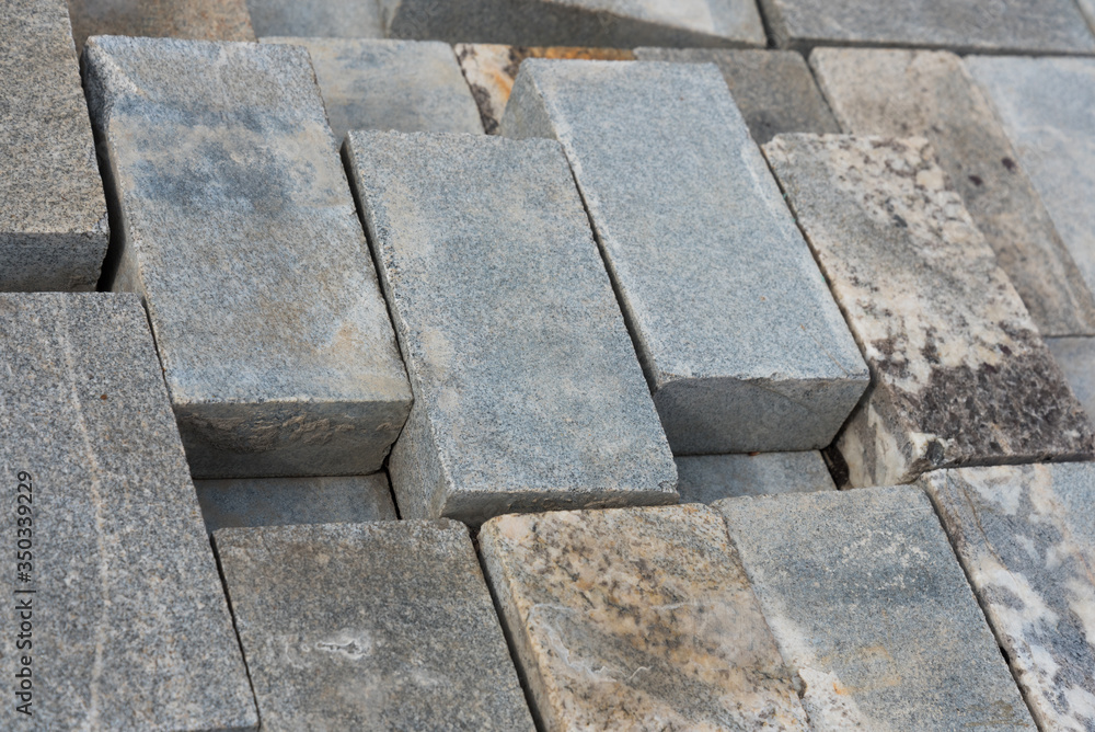 Marble, granite tiles are stacked in a row after use. Background, texture. Marble, granite tiles are stacked in a row after use. Background, texture.