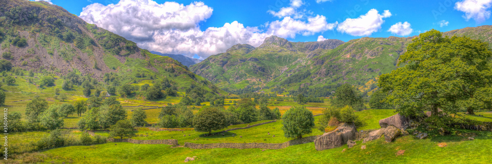 Langdale Valley Lake District Cumbria with mountains blue sky and clouds on beautiful summer day in colourful hdr