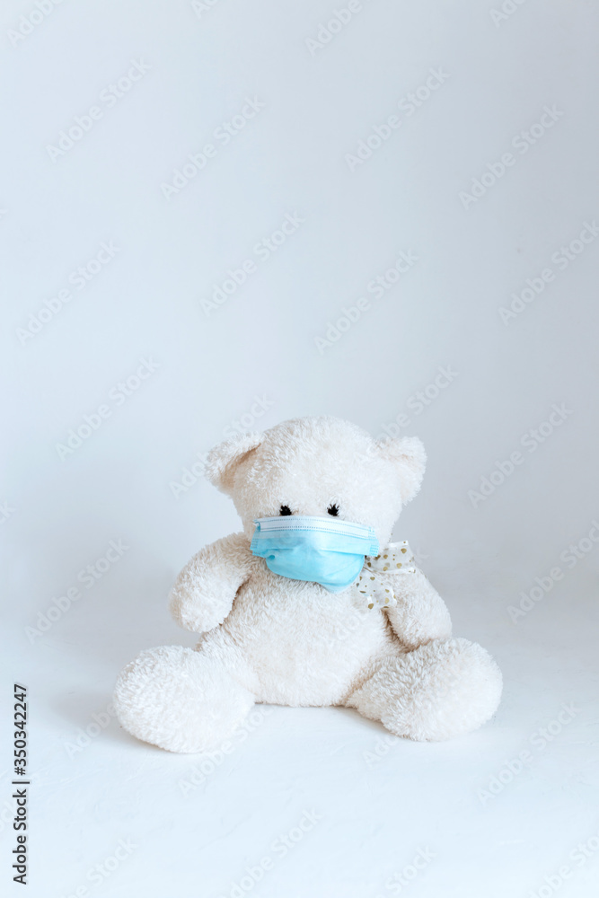 soft toy in a medical mask on a white background