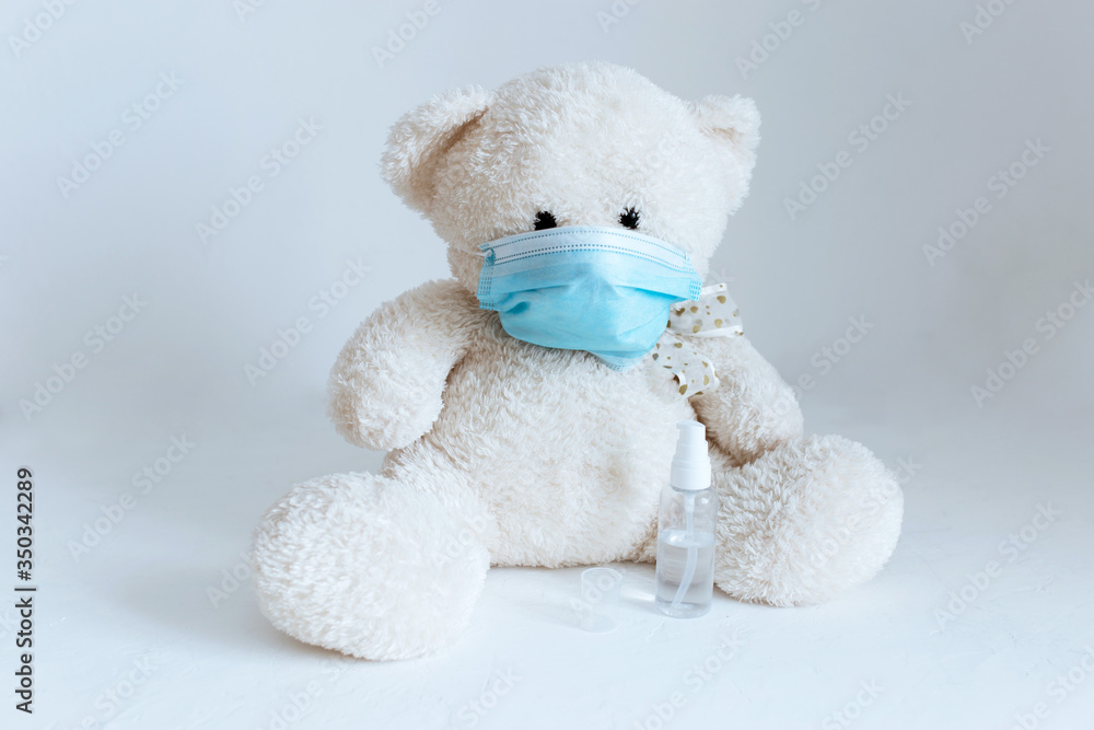 soft toy with an antiseptic in a medical mask on a white background