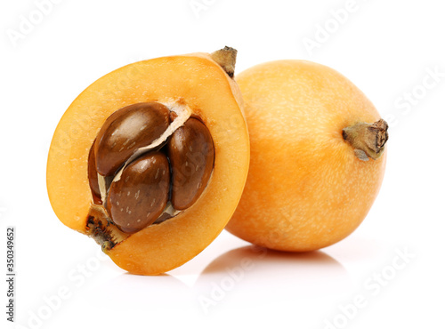 Photos Close up view of some loquat fruit isolated on a white background