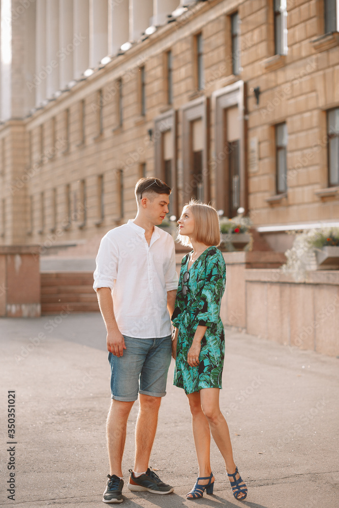 Young couple in love is hugging. In the city, a summer love story. Full height photo