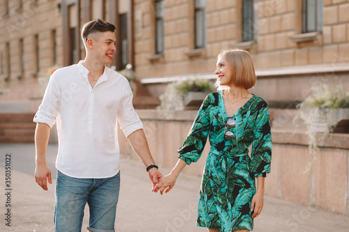 Young couple in love is hugging. In the city, a summer love story. Full height photo