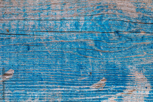 A blue old peeling painted wooden wall