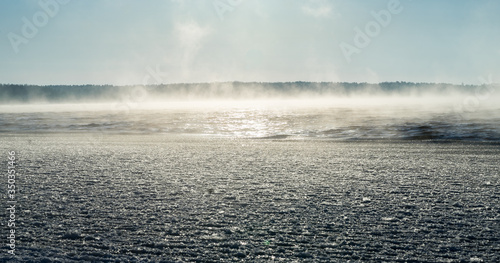 Steaming frozen Baltic Sea. Rare occasion when sea water is warmer than air above. Frost and chilly feeling. Sunrise time. Cold winter morning on the beach. Estonia, Baltic, Europe.