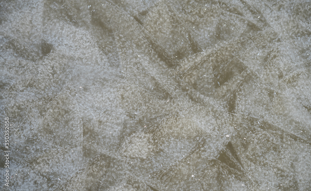 Frozen sea ice. Abstract frost pattern on the icy surface. Winter seascape on Gulf of Finland, Baltic Sea. Chilled water crystals. Estonia, North Europe. Frozen sea ice. Abstract frost pattern on the icy surface. Winter seascape on Gulf of Finland, Baltic Sea. Chilled water crystals. Estonia, North Europe.
