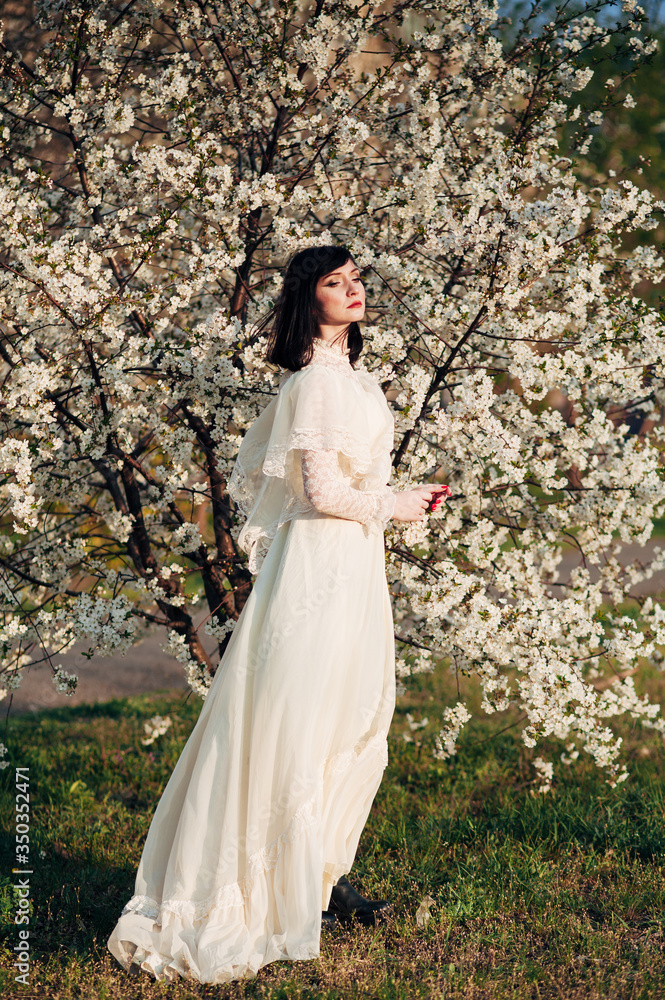 Fototapeta premium girl next to a flowering tree