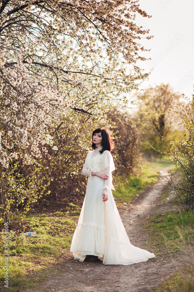 
girl next to a flowering tree