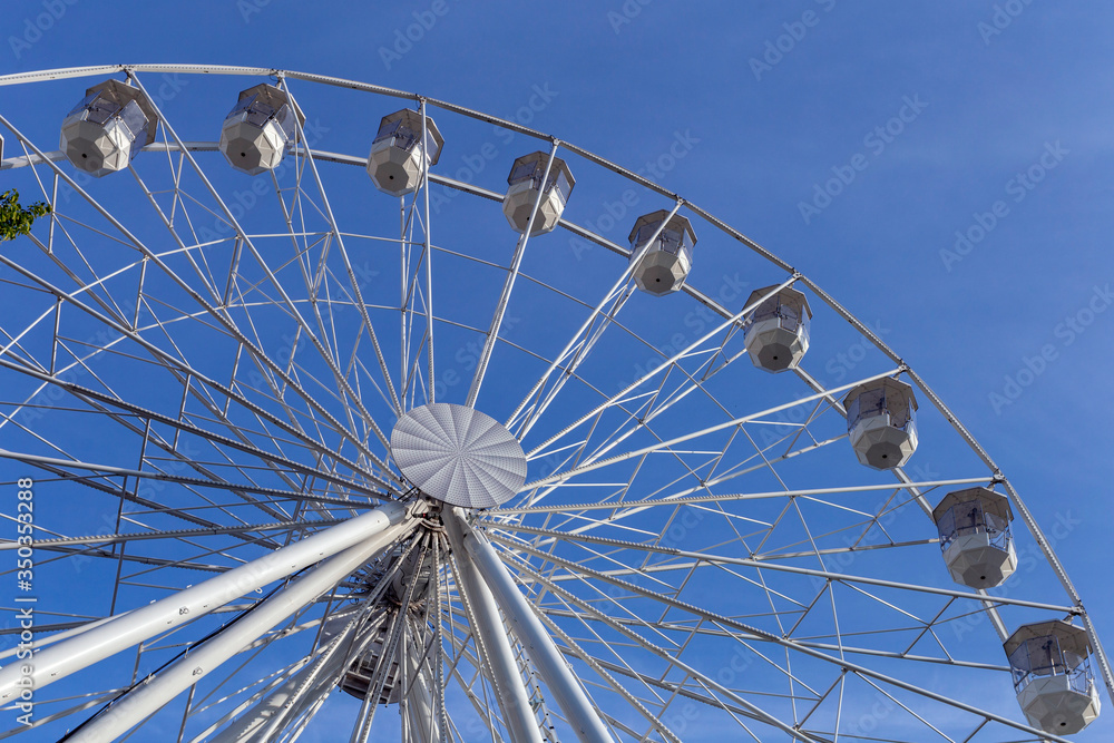 Empty ferris wheel with a blue sky in the background Empty ferris wheel with a blue sky in the background