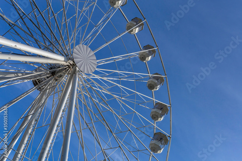 Empty ferris wheel with a blue sky in the background