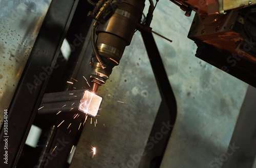 Laser cutting of metal pipe with sparks on tube laser machine