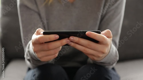 Close up 4k video of a young woman using a smartphone at home.