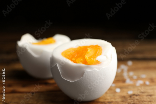 Tasty boiled chicken eggs on wooden table, closeup