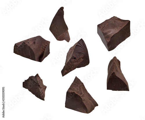 Cracked chocolates / broken chocolate chips or chocolate parts from top view isolated on white background	