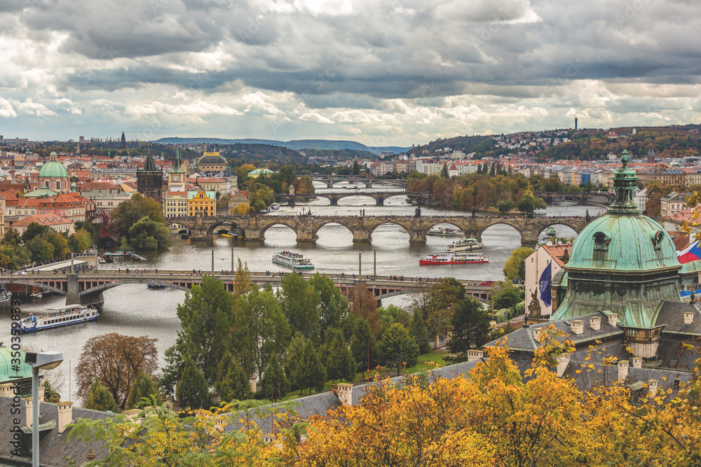 bridges over river in Prague with clouds