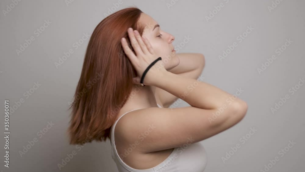 Young beautiful woman doing hair style, smiling girl make ponytail hairstyle in bathroom or bedroom in the morning. Getting ready during everyday routine at home. Young beautiful woman doing hair style, smiling girl make ponytail hairstyle in bathroom or bedroom in the morning. Getting ready during everyday routine at home.