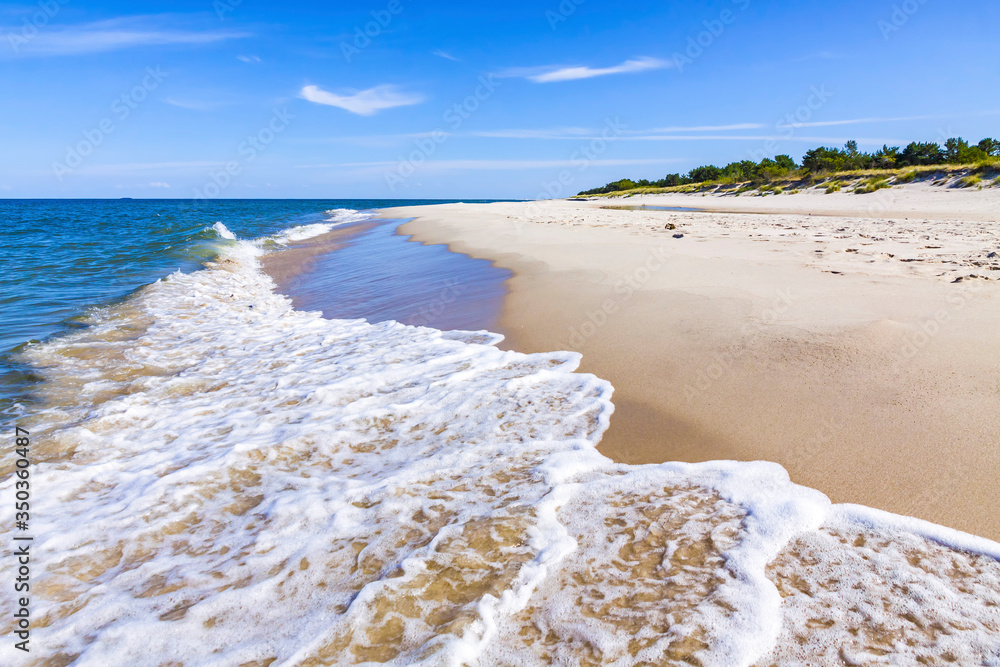 Beautiful sandy beach on Hel Peninsula, Baltic sea, Pomeranian Voivodeship, Poland. Hel is a 35-km-long sand bar peninsula in northern Poland separating the Bay of Puck from the open Baltic Sea