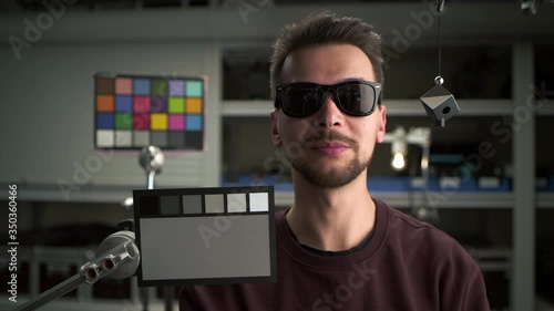 Video balanced by ColorChecker. Man testing professional film camera. ColorChecker Gray Scale, Classic Card and spidercube. It helps to ensure eccurate color balance. ARRI Alexa Mini, Lens 32 mm photo