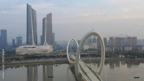 sunset time nanjing city famous international youth cultural center pedestrian riverside bridge aerial panorama 4k china photo