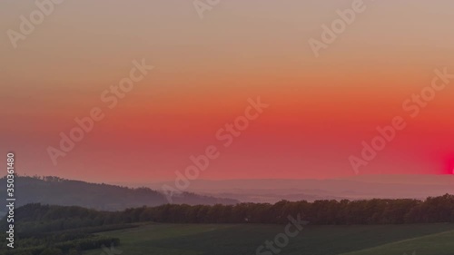 Wallpaper Mural Timelapse of the fast setting sun over the panorama of mountains and hills and the surrounding nature orange-red sky and a large bright sun sets beyond the horizon of the Beskydy hills. Torontodigital.ca