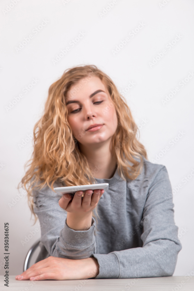The girl holds a tablet on white background. Preparation for technology design. The girl holds a tablet on white background. Preparation for technology design.