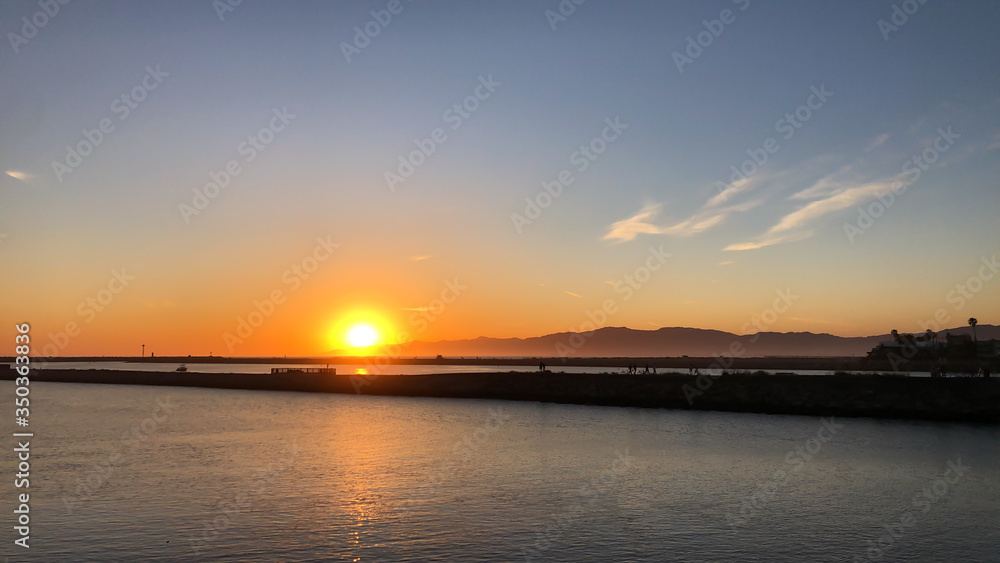 Sun sets over Pacific Ocean in Marina del Rey, CA
