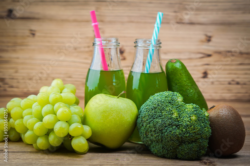 Vegetarian healthy food. Source of protein for vegetarians. Healthy eating  vegetable  broccoli  kiwi  leaf vegetable  apple  grapes  juice on wooden table.