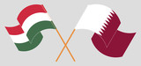 Crossed and waving flags of Hungary and Qatar