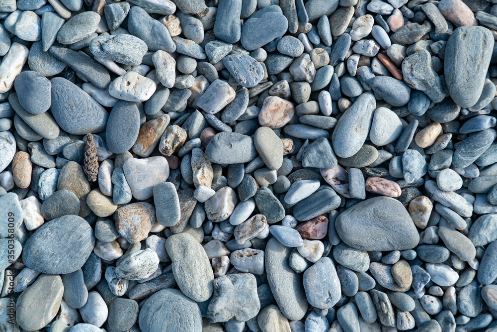 Blue pebbles closeup. Blue pebbles. Background from a natural stone of blue, turquoise hue. Pebbles texture