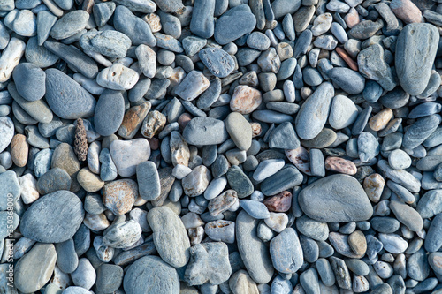 Obraz na płótnie Blue pebbles closeup. Blue pebbles. Background from a natural stone of blue, turquoise hue. Pebbles texture w salonie