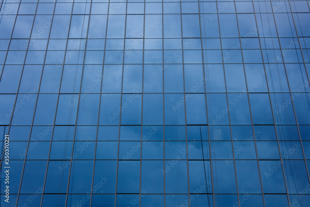 Glass facade of a modern office building. Glass facade of a modern office building.