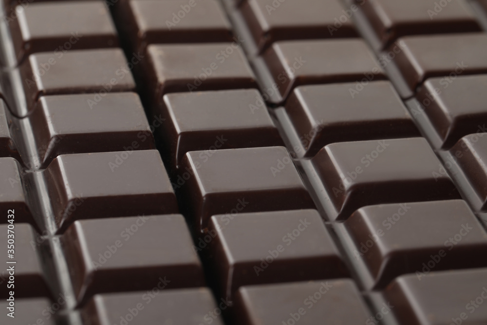 Delicious dark chocolate as background, closeup view Delicious dark chocolate as background, closeup view
