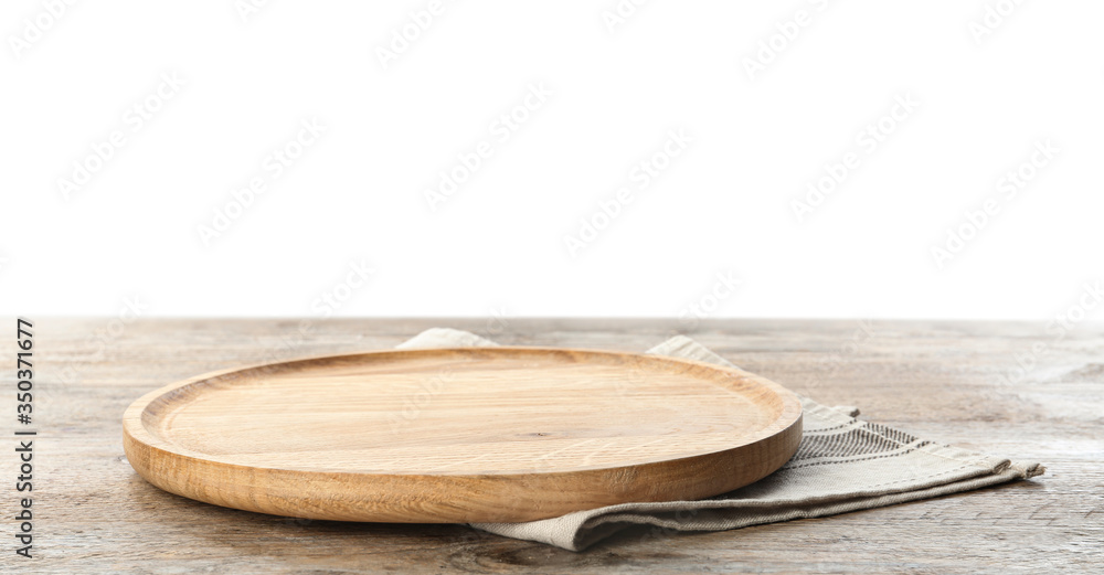 Empty plate and napkin on wooden table against white background Empty plate and napkin on wooden table against white background