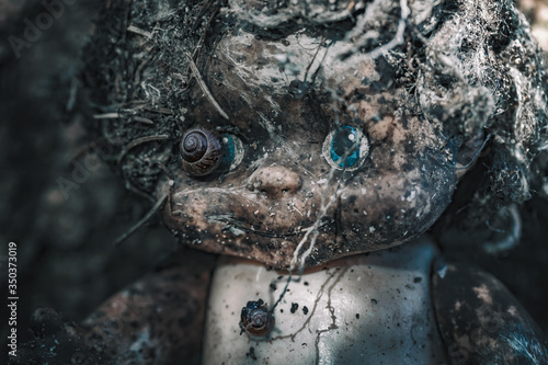 Art-photo. The head of an old abandoned doll in the forest. © Black_Cherry_Spb