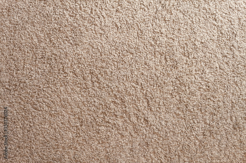 Beige carpet texture. Cozy soft floor at home